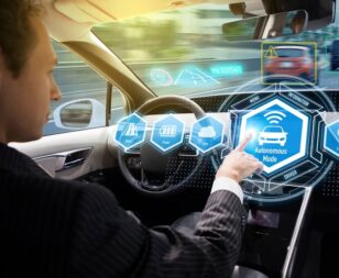 Driver in autonomous mode using self-driving car technology on Texas road — self-driving car accident lawyer