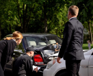 Police officer writing a Texas car accident police report at crash scene
